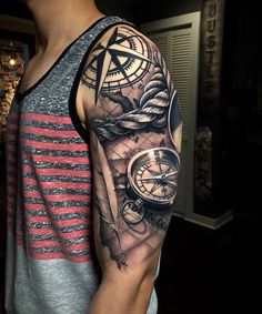 a man's arm with a clock and compass tattoo on it