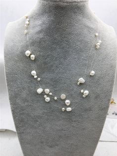 "quantity: 1 strand pearl jewelry: floating pearl necklace pearl body: please look at picture necklace length: 17.5 inches pearl grade:AA pearl luster:high pearl shape: nugget pearl color: white ---All style of illusion necklace--- https://www.etsy.com/hk-en/shop/WenPearls?ref=hdr_shop_menu&search_query=NPN3 Back to Other Jewelry Section 01: \"Tahitian,Akoya,Sea Pearl\" Section: https://www.etsy.com/shop/WenPearls?section_id=15806339 02: \"Potato/Near Round Pearl\" Section: https://www.etsy. White Pearl Chain Layered Necklace For Wedding, White Double Strand Pearl Necklace For Party, White Double Strand Pearl Layered Necklace, White Pearl Double Strand Layered Necklace, Multi-strand White Pearl Necklace For Parties, White Multi-strand Pearl Drop Necklace, Affordable White Multi-strand Pearl Necklace, Classic Pearl White Multi-strand Necklaces, Leather Pearl Jewelry