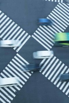 an overhead view of cars driving on the road with crosswalks painted in white