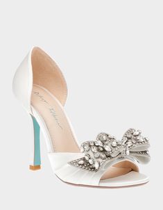 The LANDN is the perfect choice for a formal bridal shoe. Crafted with luxurious material, it is designed with a beautiful stone bow detail for an elegant touch. Take the next step in style with this sophisticated and classic shoe. Textile upper material with stone bow embellishments Synthetic lining Betsey Blue synthetic sole 4 inch heel height Imported Peep Toe Wedding Shoes, Bow Embellishments, Best Bridal Shoes, Wedding Shoes Low Heel, Bridal Shoe, Mini Wedding Dresses, Bow Women, Embellished Heels, Bridal Heels