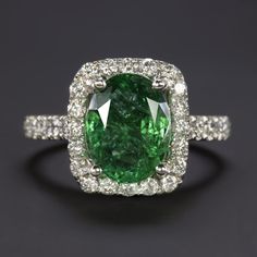 an oval cut green and white diamond ring