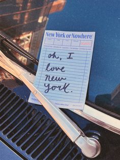 a pair of scissors sitting on top of a piece of paper that says i love new york