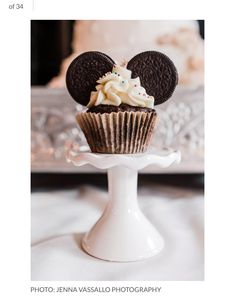 there is a cupcake with mickey mouse ears on it