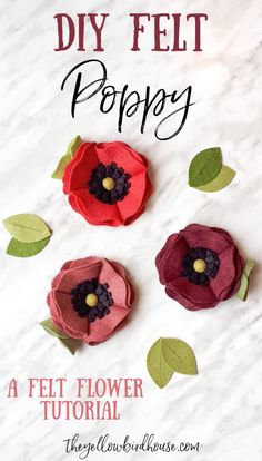 three felt flowers sitting on top of a white surface with the words diy felt poppy