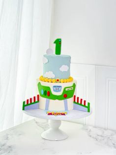 there is a cake that looks like a train on top of a stand with the number one on it