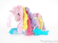 a toy pony with long blonde hair and rainbow manes