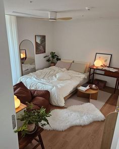 a bedroom with a bed, couch and table in it's centerpieces