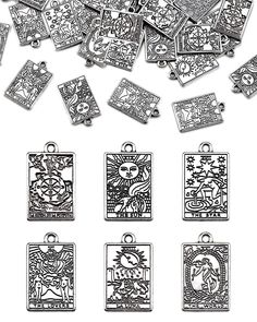 a bunch of metal tags with designs on them