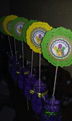 there are some crocheted paper flowers on sticks