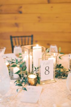 the table is set with candles and place cards