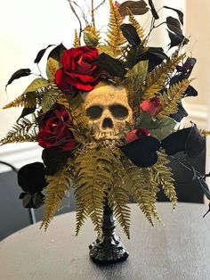 there is a skull with flowers in it on the table