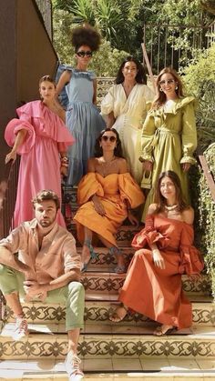 a group of women and men posing on steps