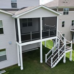 the back side of a two story house with an attached deck