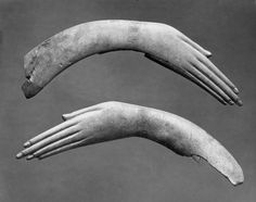 an old photo of two long, curved objects in the shape of hands and fingers