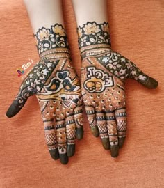 two hands with henna designs on them