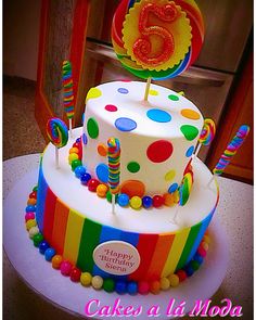 a birthday cake decorated with colorful candies and lollipops for a child's 5th birthday