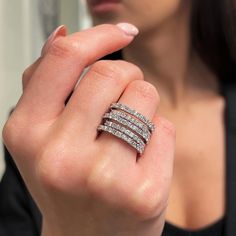 a woman wearing three bands of diamonds on her wedding ring, with one band in the middle