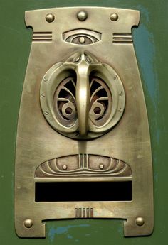 a close up of a metal object on a green door with rivets and circles