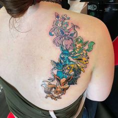 the back of a woman's shoulder with pokemon tattoos on it