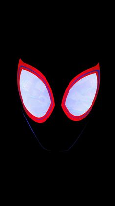 the face of an alien with glowing red eyes and large, oval shaped ears is shown against a black background