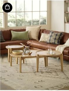 a living room filled with furniture and lots of pillows on top of it's couches