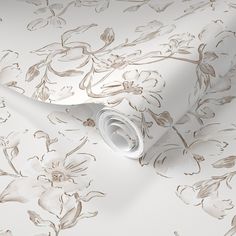 a wallpaper with white flowers on it and a roll of paper next to it