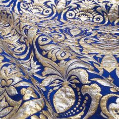 gold and blue fabric with an intricate design