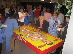 a group of people standing around a table that has a game on top of it