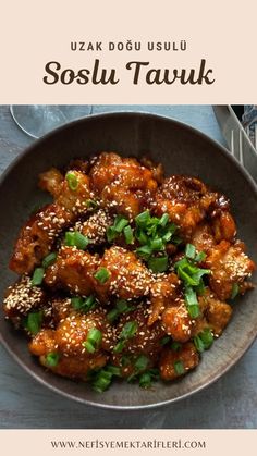 a bowl filled with chicken covered in sesame seeds