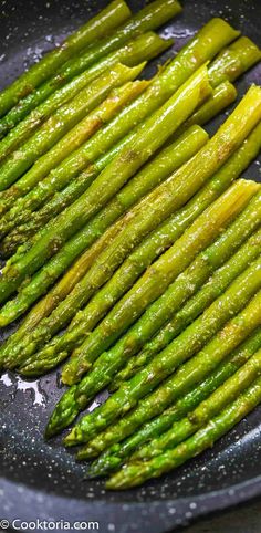 asparagus being cooked in a frying pan