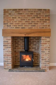 a brick fireplace with a wood burning stove