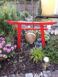 a small garden with flowers and a statue