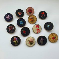 nine embroidered flowers are shown in different sizes and colors, along with numbers on each side