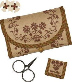 a pair of scissors and some fabric on a white background with other items to make it look like an embroidered purse