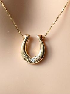 "Hanging a horseshoe facing upwards in a \"U\" shape is said to keep evil out and bring good luck and protection. Whether you believe the legend or not, you have to admit, this lucky horseshoe necklace makes interesting jewelry you must have!  Proudly Handmade in Montréal Canada   If you want your birthstone, we can do it!!  Details: Metal Purity: 14K Gold Height : 17mm  Width: 15mm  Stone: Natural Diamond Quality: VS-H Size: 0.05ct Weight:  4.3g Approximately Condition: New Please understand that the photos are ENLARGED to show detail for your benefit- please use the measurements provided in the item details/description to understand the size of the gem or Jewelry in the listing- measurements are given in millimeters unless otherwise noted. Please check the photos & sizes in the descripti Horseshoe Pendant Necklaces, Woman Gold Necklace, Horse Shoe Necklace, Horseshoe Necklace Gold, Equine Jewelry, Horseshoe Jewelry, Interesting Jewelry, Necklace With Diamond, Country Jewelry