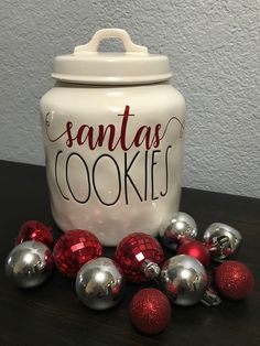 a cookie jar with christmas ornaments around it