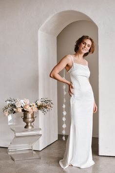 Get ready to stun in the Belle Rosette Maxi Dress. Perfect for your rehearsal dinner, this floor-sweeping white satin dress is the epitome of bridal glamour. Adorned with a unique rosette train attached to the shoulders, it's sure to turn heads. With a hidden zipper back and floor length cut, this dress will make you feel like the ultimate bride-to-be. Runs very small; we recommend sizing up. Wedding Slip Dress With Bias Cut And Fitted Bodice, White Satin Dress For Bridal Shower, Elegant Wedding Dress With Fitted Bodice For Bridal Shower, Fitted Satin Dress For Bridal Shower, White Satin Gown With Bias Cut, Elegant Fitted Wedding Dress For Bridal Shower, Floor-length Slip Dress With Fitted Bodice For Wedding, White Bias Cut Bridesmaid Gown, Elegant Dresses With Fitted Bodice For Bridal Shower