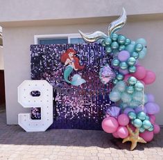 a mermaid themed birthday party with balloons and decorations