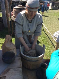 a woman is making something in a bucket