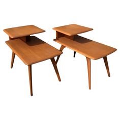 two wooden tables sitting next to each other