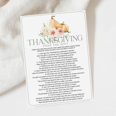 a thanksgiving poem with pumpkins and flowers on it sitting next to a white cloth