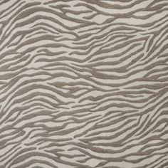 an animal print rug with grey and white stripes