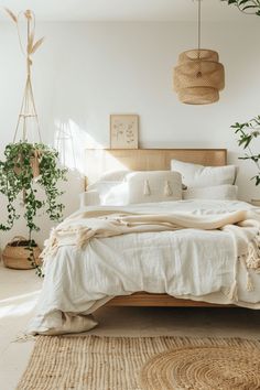 a bed with white linens, pillows and blankets on top of it in a bedroom