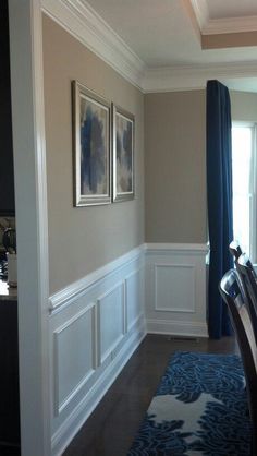 an empty dining room with blue and white decor