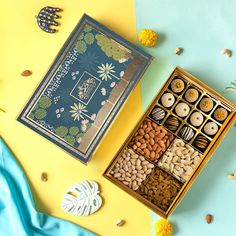 an assortment of nuts in a box on a blue and yellow background