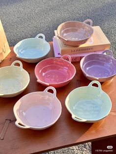 six different colored dishes are on a table