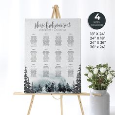 an easel with a table plan on it next to a potted plant and white flowers