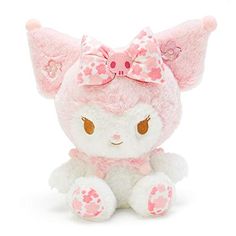 a stuffed animal with a pink bow on it's head and ears, sitting in front of a white background