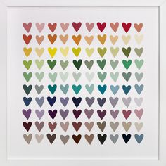 an art print with hearts in different colors and sizes on the wall above it is a white frame