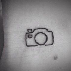 a camera tattoo on someone's stomach